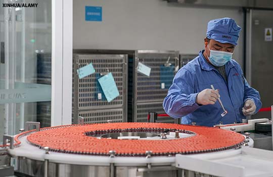 An employee works on the production line for a covid-19 vaccine